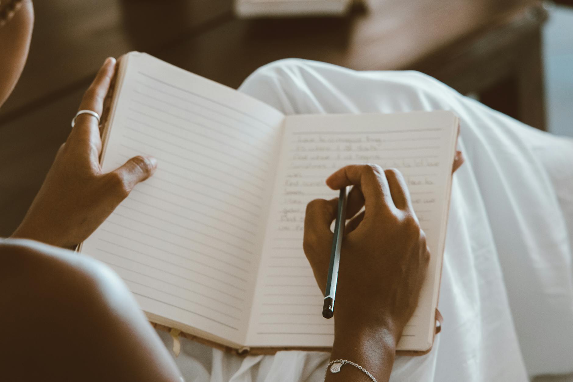 a person writing on a notebook